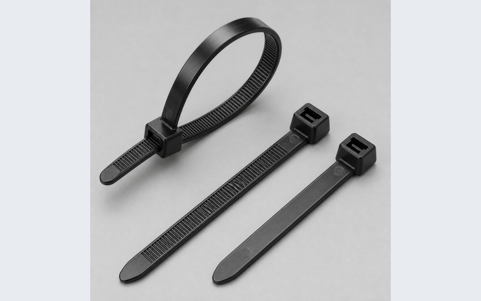 Heavy-duty black nylon cable tie head teeth and tapered tail detail