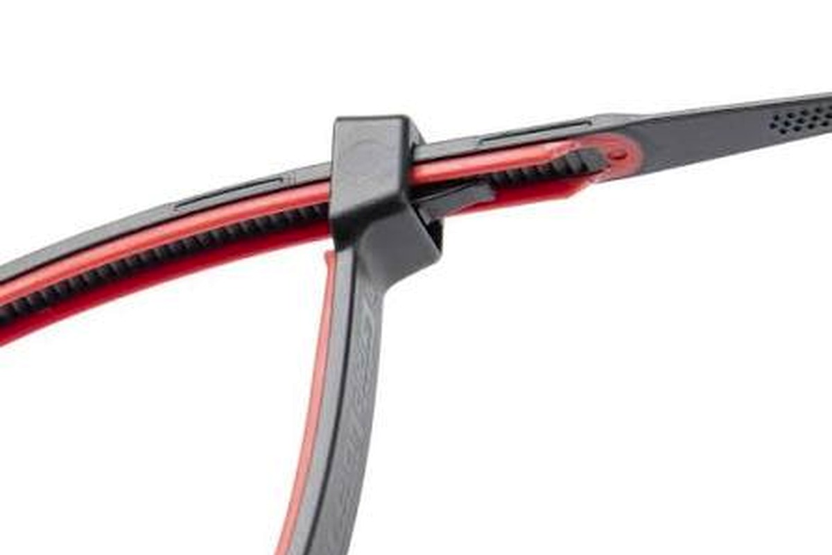 Close-up cable tie fastening around a hose and wire bundle
