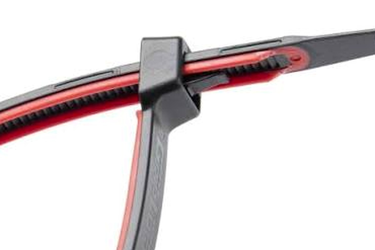 Close-up hose support detail with a cable tie wrapped around the route